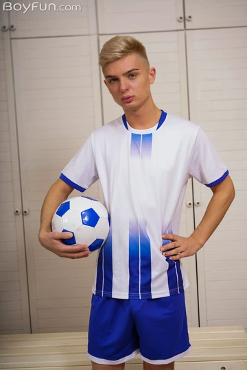 Cute football boy getting naked
